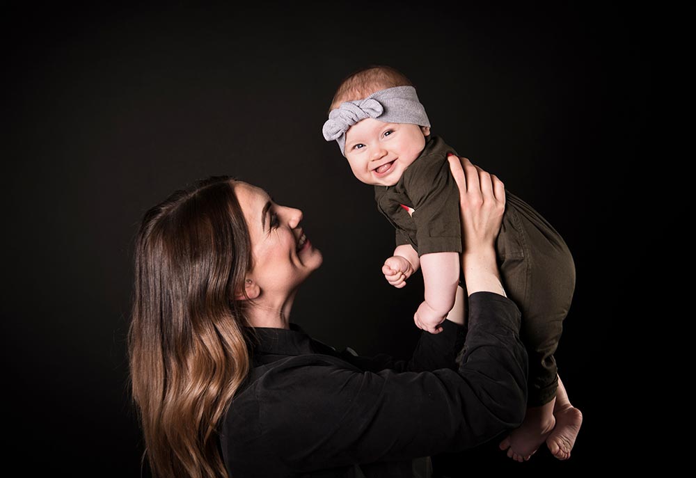 a mum holding her baby for a baby portrait session