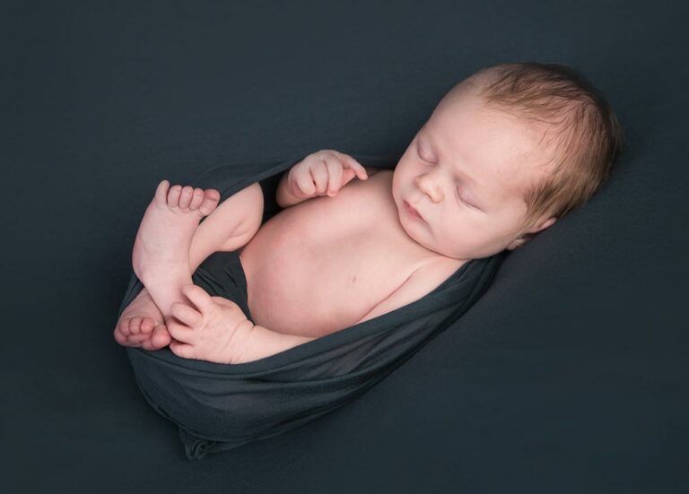 Newborn Baby wrapped in a blanket for newborn photography