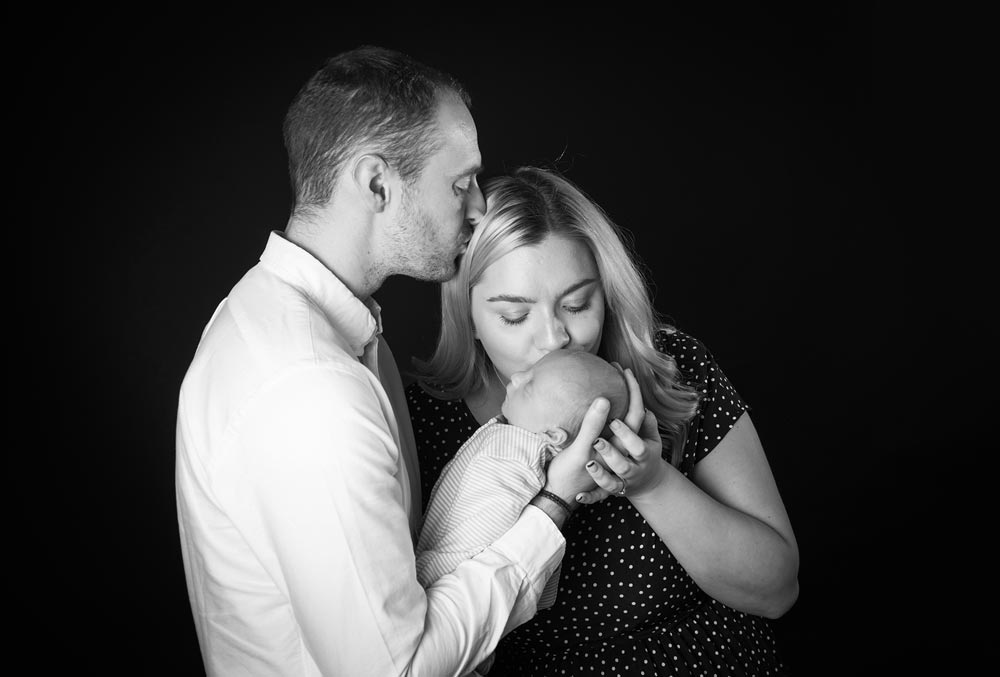a couple with a newborn baby in black & white from a newborn photoshoot session