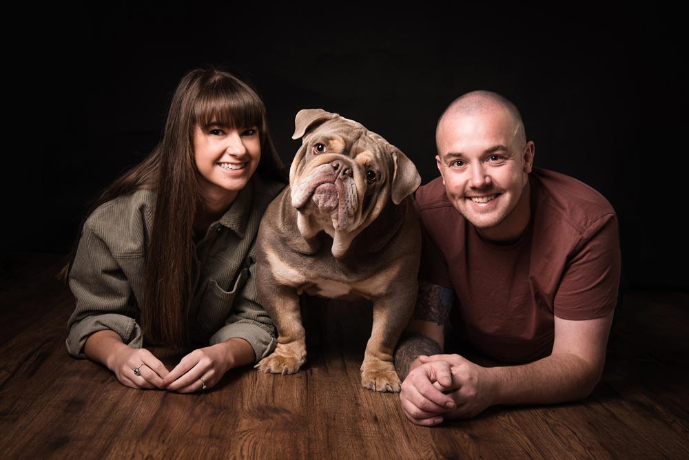 Male and female with a dog in the middle for a photography pet portrait