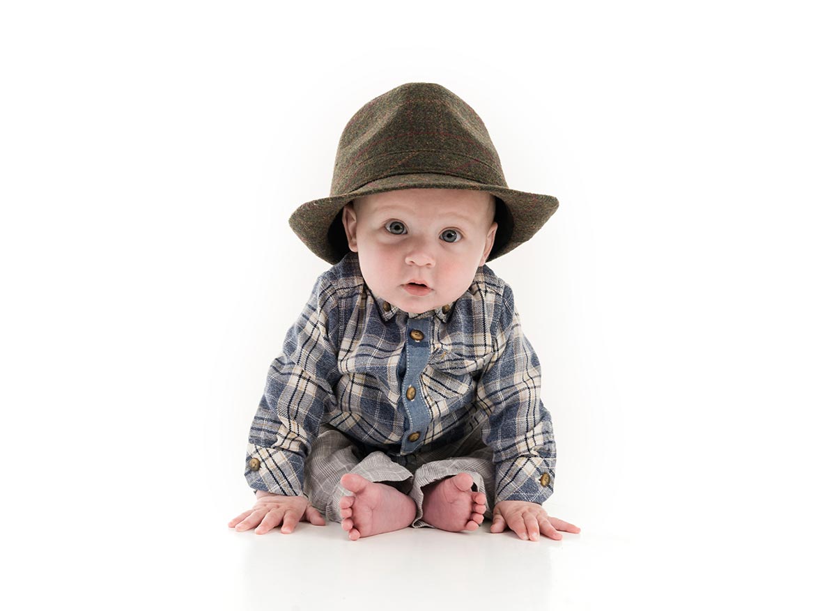 a boy with a hat at a children's portrait photo session