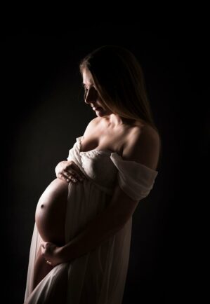 Lady with baby bump showing for a professional maternity photoshoot