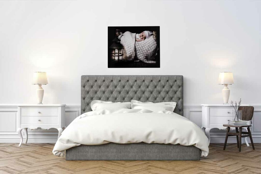picture ahowing a bedroom setting with a babies portrait on the wall reproduced on a photo panel product