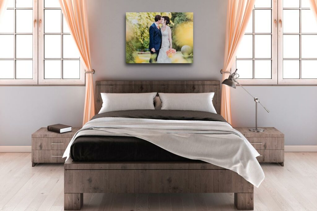 A Canvas Print of a wedding photograph with the bride & Groom on a Wall above a bed